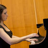 Woman playing grand piano 