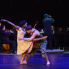 Two dancers in front of a chamber ensemble of musicians