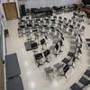 Chairs and music stands set up in three semi-circles 