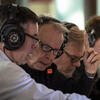 Recording technician and others review audio of a live performance.