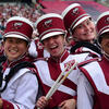 Four students in marching band uniforms 